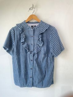 Ace & Jig x Barney’s Blue and Black Stripe Ruffle Top. A short sleeve button down shirt with a ruffle panel at the chest. Boxy cut. In excellent condition. Marked size L. 100% cotton. Machine wash cold. Made in India. Approx. Measurements: Underarm to underarm: Up to 21" Length: 25" Ace Jig, Ace And Jig, Ruffle Top, Blue And Black, Black Stripes, Button Down Shirt, India, Blue, Black