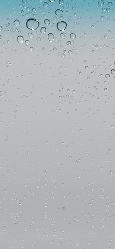 water drops on the glass surface with blue sky in background