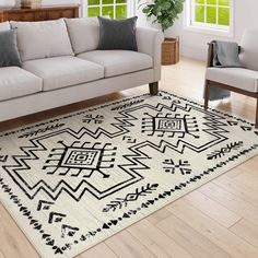 a living room with white couches and a black and white rug on the floor