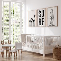 a baby's room with white walls and wooden flooring, artwork on the wall