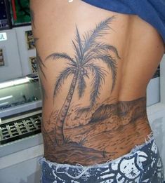 a person with a palm tree tattoo on their back is standing in front of a refrigerator