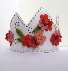 a white crown with red and pink flowers on it