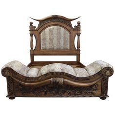 an ornate wooden bed with white pillows on it