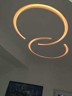 a circular light fixture is suspended from the ceiling