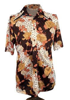 This is a nice vintage men's short sleeve shirt from the 70s. Label reads, " Fordham -Bardell for Haband". Tagged a size large. Chest measures 46", please see measurements below.  It is made of silky nylon in an orange, cream tan & brown floral print. It is a short sleeve with a button down front. Sleeves have cuffs that are sewn flat. Hemline is a straight hemline. No pockets. The shirt is in good vintage condition. No damage or soil. If you have never worn vintage, please measure yourself or a similar garment. Please know your measurements before buying, as vintage sizes tend to run smaller than today's sizes. Measurements were taken with the garment lying flat. Chest measured from side seam to side seam 2" below the underarm seam: 23" for a 46" or smaller chest Hemline measured from sid Retro Fitted Short Sleeve Shirt, Retro Short Sleeve Shirt With Button Closure, Brown Floral Print, Mens Short Sleeve Shirt, Button Front Shirt, Brown Floral, Tan Brown, Vintage 70s, Vintage Men