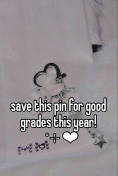 a white teddy bear sitting on top of a bed next to a keychain that says save this pin for good grads this year