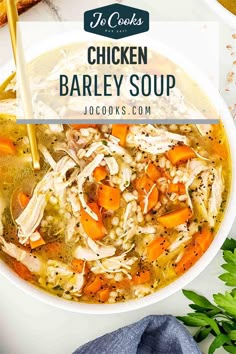 chicken barley soup with carrots and parsley in a white bowl