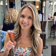 a beautiful woman holding a glass of wine