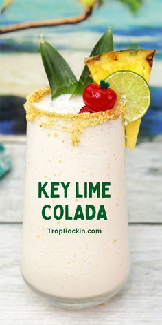 the key lime cola cocktail is garnished with pineapple and cherries on top