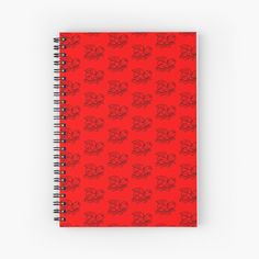 a red spiral notebook with skulls on it