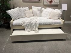 a white couch with lots of pillows on it