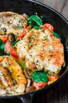 chicken and vegetables cooking in a skillet