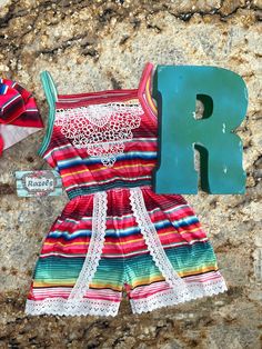 I love Serape and I love the ease of rompers! And I hope you do too! This Serape Romper is the most adorable color combo of pinks, red, blues and greens! Up to 2t has legs snaps, 3t and above do not. FIT: ⏩ If your child has a long torso you may want to size up 1 size. Please refer to size chart. High quality lace, bright Serape stripes and the ease of leg snaps.... I mean come on Summer! 😎 Because each romper is unique and one of a kind, pattern placement will vary 95% Cotton 5% Spandex Machin Cute Multicolor Jumpsuits And Rompers For Playtime, Multicolor Jumpsuits And Rompers For Spring Playtime, Playful Red Jumpsuits And Rompers For Summer, Cute Pink Jumpsuits And Rompers For Vacation, Playful Red Summer Jumpsuit, Playful Multicolor Jumpsuits And Rompers For Spring, Spring Playful Multicolor Jumpsuits And Rompers, Cute Pink Beach Jumpsuits And Rompers, Cute Pink Jumpsuits And Rompers For Beach