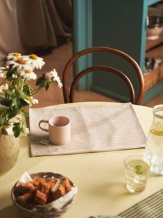 a table topped with plates and cups filled with food