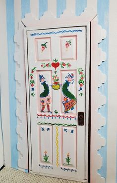 a painted wooden door with decorative designs on it