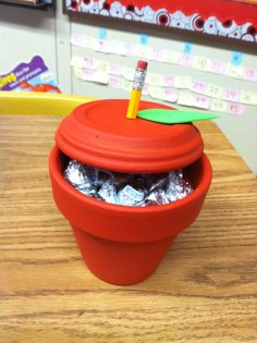 an apple shaped container with candy in it