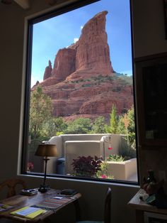 a view out the window of a room with a mountain in the backgrouund