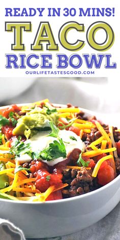 the recipe for taco rice bowl is in a white bowl and has cheese on top