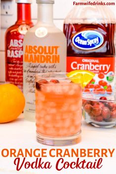 an orange cranberry vodka cocktail is garnished with cherries