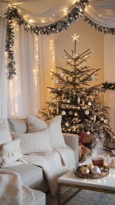 a living room with a christmas tree in the corner and lights strung up on the ceiling