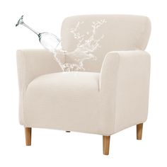 a white chair with a glass vase on top of it's arm and legs