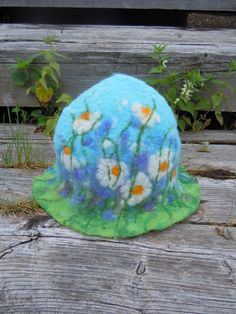 Beautiful hat with meadow of daisies on it. Unique hat in which you will feel amazingly good. Hat has a wide usage: it can be a sauna hat or a hat for a special occasion or teapot warmer. As a sauna hat it will protect your head and hair from the heat, as teapot cover it will keep the teapot warm. This hat is made of 100% wool using wet felting technique. Materials: New Zealand sheep wool 100% This hat is not on stock. This hat is made to order. Final product will be a little different than this Spring Brimmed Felt Hat, Spring Felt Brimmed Hats, Spring Curved Brim Felt Hat, Handmade Spring Cloche Hat, Fairy Hat, Sauna Hat, Teapot Warmer, Felted Hats, Teapot Cover