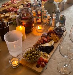 an assortment of food and candles on a table