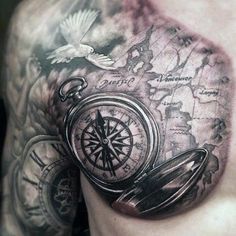 a man's chest with a compass tattoo on it and an eagle flying over the map