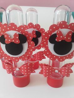 minnie mouse wine glasses with red bows and polka dots on the top are ready to be used as centerpieces