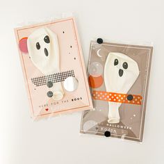 two halloween greeting cards, one with a ghost face and the other with a cat's head