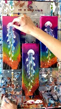 someone is painting jellyfish on canvases with acrylic paint