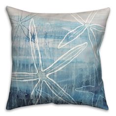 a blue and white pillow with an image of a starfish in the water on it