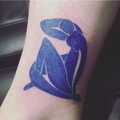 a person with a blue tattoo on their foot