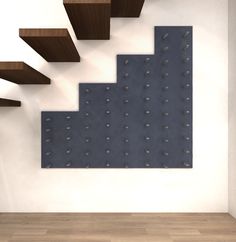 an empty room with some shelves on the wall and a blue carpeted stair case