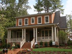 a small house with porches and steps leading to the front door