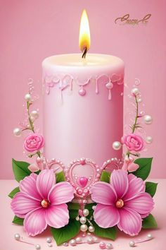 a pink birthday cake with flowers and pearls on the side, lit by a single candle