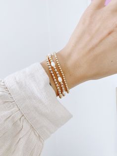 We have teamed up with Simple Joys Shop to bring you a collaboration of premium beaded gold filled wrist wear. These bracelets are created custom to your wrist size. ∙ D E T A I L S ∙ - Crafted with Fresh Water Pearls - 4mm Beads- 18k Gold Filled Beads- Made with strong stretch cord to your custom size! ∙ G O L D ∙ F I L L E D ∙ Gold-filled components contain 100+ times more real gold than gold-plated components and are both durable and tarnish resistant. It is more affordable and accessible than solid gold but higher quality than gold plated. Everyday Gold Beaded Bracelet Jewelry, Rose Gold Stackable Beaded Bangle Bracelets, Everyday Bracelets With 14k Gold Beads, Everyday 14k Gold-filled Bracelets With Gold Beads, Hypoallergenic 14k Gold Filled Pearl Bracelet For Everyday, Everyday Hypoallergenic 14k Gold Filled Pearl Bracelet, Everyday 14k Gold Filled Pearl Bracelet, Everyday 14k Gold-filled Pearl Bracelet With Gold Beads, Rose Gold Beaded Jubilee Bracelet For Everyday