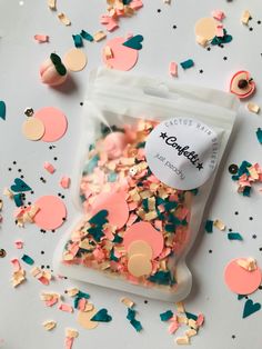 confetti sprinkles in a bag on a table with confetti