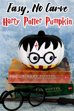 harry potter pumpkin sitting on top of books with the title easy, no carving harry potter pumpkin