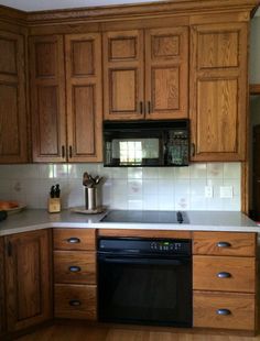 a kitchen with wooden cabinets and white counter tops