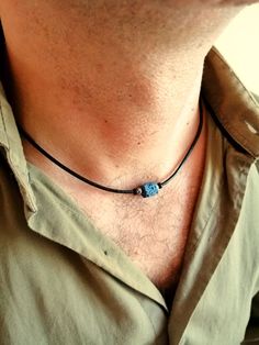 "Mens choker necklace in minimalist style made with natural lava stone bead blue color, stainless steel rondelle beads and black wood beads on black leather cord, stainless steel lobster clasp closure.  Simple everyday leather rope necklace for men, blue bead choker for him. This minimalist leather necklace will be a perfect gift for him. Necklace length: 18 inches (45 cm) lava stone beads: 10 mm wooden beads: 3 mm Stainless steel beads: 3 mm Lava Stone is a grounding stone that strengthens one's connection to Mother Earth. It gives us strength and courage, allowing us stability through times of change. It provides guidance and understanding in situations where we may need to \"bounce back\". A calming stone, it is very useful in dissipating anger. For all products are used only genuine hi Minimalist Adjustable Lava Stone Jewelry, Minimalist Blue Jewelry With Adjustable Cord, Mens Choker, Beaded Necklace For Men, Mens Choker Necklace, Leather Beaded Necklace, Bead Choker, Necklace Minimalist, Men Jewelry