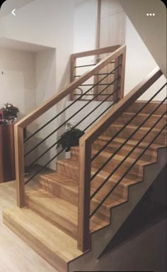 a wooden staircase with metal handrails in a home