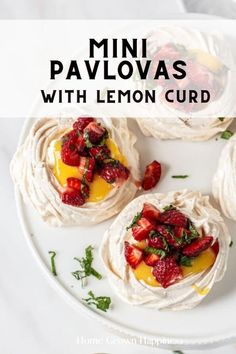 mini pavlovas with lemon curd and strawberries on a white plate