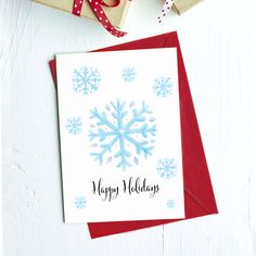 a christmas card with a snowflake design on it, next to some presents