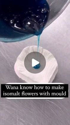 someone pouring blue liquid into a bowl on top of a white surface with the words, want to know how to make isomani flowers with mould