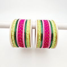 Beautifully designed bangles for any occasion. South asian bracelets come in a variety of styles, colors, and finishes. We at Banglez take creating the perfect bangle set for you to another level! You could say helping you find your favorite stack of bangles as one of our greatest missions. This bangle set was curated in house by one of our talented team members. We hope you love them as much as we do! Traditional Adjustable Pink Bangle, Bohemian Stackable Bangle For Party, Stackable Bohemian Bangle For Party, Bohemian Pink Festive Bangle, Pink Bangle Jewelry For Festival, Handmade Pink Bangle For Festive Occasions, Traditional Stackable Bracelets For Party, Handmade Pink Beaded Bracelets For Festive Occasion, Pink Bohemian Bangle For Party