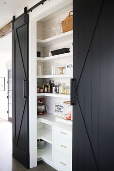 an open pantry with sliding doors and shelves