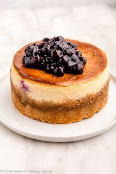 a cheesecake topped with blueberries on a white plate