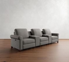 a row of chairs sitting on top of a wooden floor next to a white wall