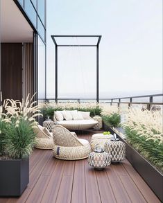 a wooden deck with lots of furniture and plants on it, along with an ocean view